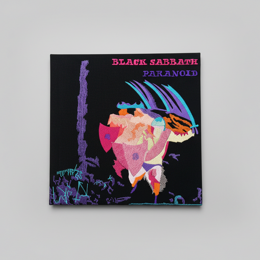 Hand holding a Black Sabbath 'Paranoid' album cover